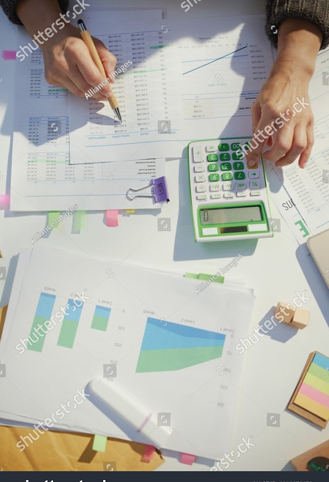 stock-photo-accountant-woman-with-calculator-and-documents-working-in-office-2218373471.jpg