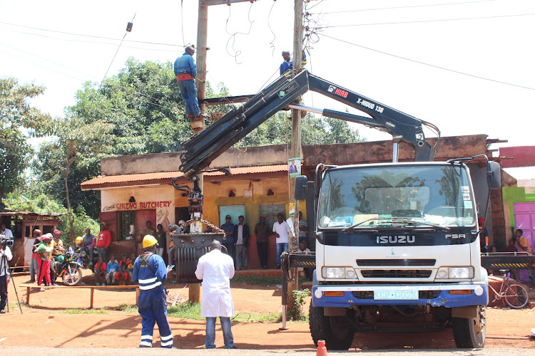 Kenya Power workers remove a vandalized transformer at Kiawaihiga shopping centre in Gatanga, Murang'a, on April 6, 2022.