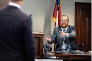 Travis McMichael speaks from the witness stand during the trial of Greg McMichael, his son Travis McMichael and William 