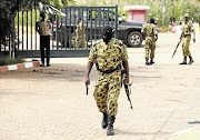 GUARDIAN OF DEMOCRACY? A presidential guard member arrives at the Laico Hotel in Ouagadougou, capital of Burkina Faso, yesterday. Pro-coup demonstrators invaded the hotel, which was due to host talks aimed at hammering out the details of a deal to restore a civilian interim government, and attacked the participants