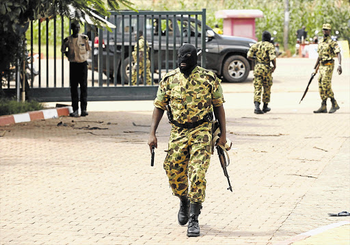 GUARDIAN OF DEMOCRACY? A presidential guard member arrives at the Laico Hotel in Ouagadougou, capital of Burkina Faso, yesterday. Pro-coup demonstrators invaded the hotel, which was due to host talks aimed at hammering out the details of a deal to restore a civilian interim government, and attacked the participants