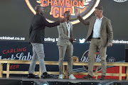 Kaizer Chiefs Steve Komphela (L), TV personality Andile Ncube and Orlando Pirates head coach Kjell Jonevret (R) during the Carling Black Label Champion Cup launch at Park Station on May 02, 2017 in Johannesburg, South Africa.