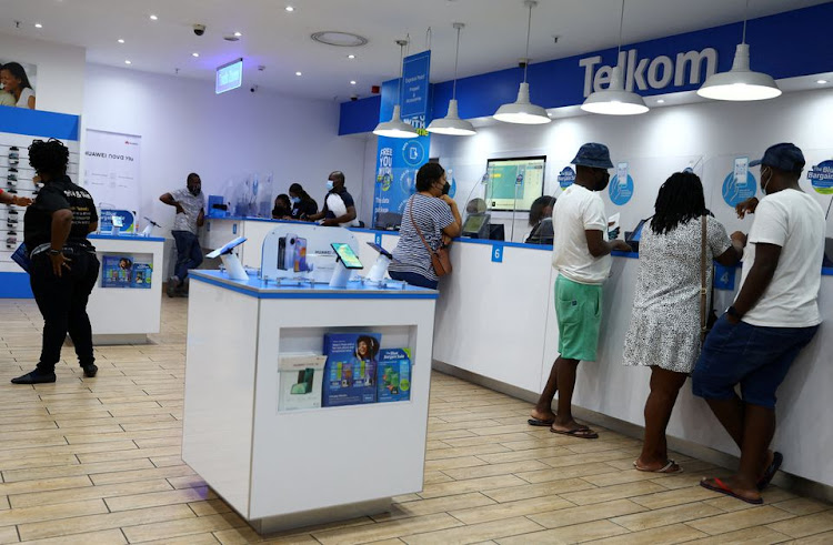 Customers are served at a branch of South Africa's mobile operator, Telkom, in Johannesburg, South Africa, March 2, 2022.