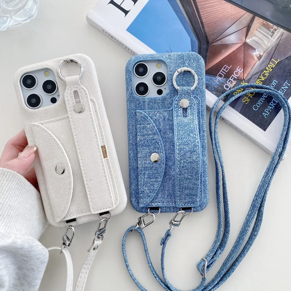 Leather Phone Case for iPhone 15 with Denim Pattern and Wrist Strap. Stylish protection and secure grip. Perfect for eve