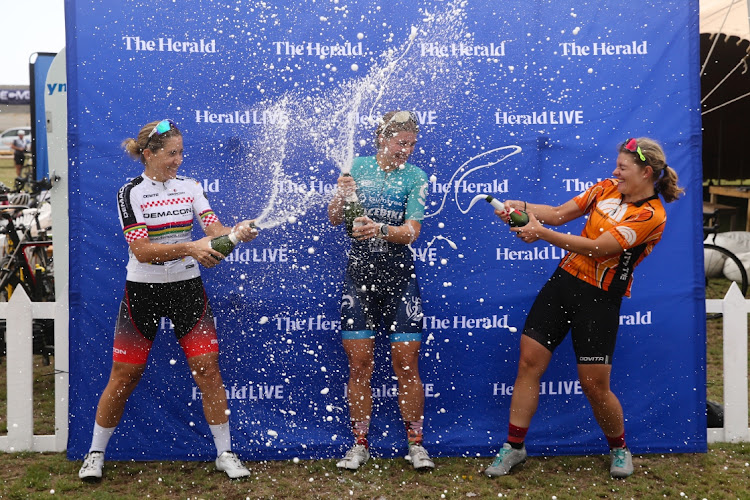 SPARKLING PERFORMANCE: Herald Cycle Tour 106km Coastal Classic women’s winner Hayley Preen, centre, celebrates at Pollok Beach with second-placed Kim Le Court, left, and Liezel Jordaan, who finished third