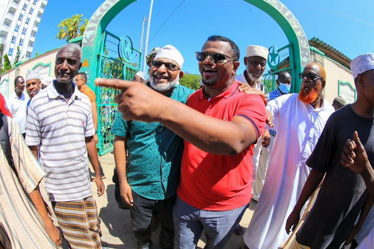 Mvita MP Abdulswamad Nassir's brother Abdulwahib and former Mombasa Senator Hassan Omar at the Kikowani cemetery after the burial of former Mombasa mayor Ahmed Mwidani on Thursday.