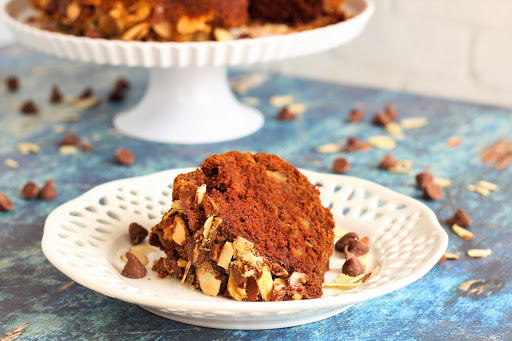 A slice of Chocolate and Zucchini Praline Bundt Cake on a plate.