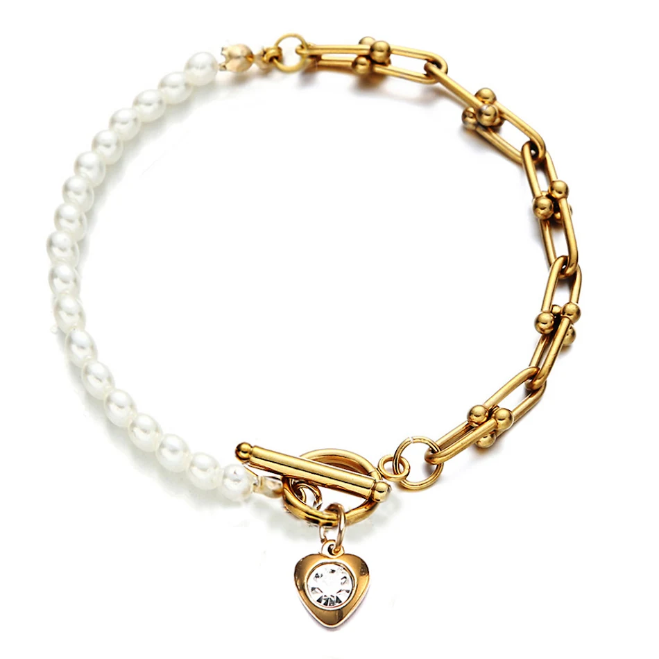 Bracelet simple en U en acier inoxydable avec couture de perles. Un accessoire élégant pour rehausser votre poignet avec une touche sophistiquée.