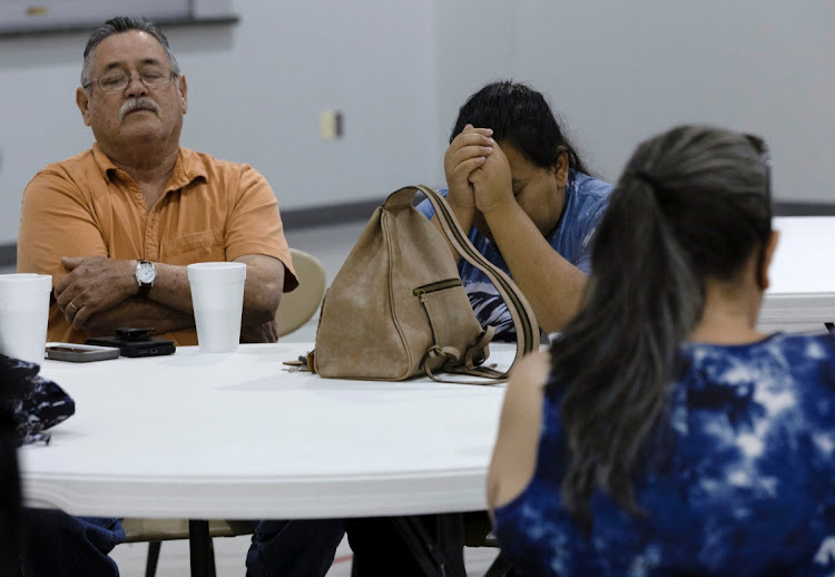 Joe Perez and his daughter, Erika Escamilla say prayers during a vigil at Getty Street Church of Christ after a mass shooting at Robb Elementary School in Uvalde, Texas, US on May 24, 2022.