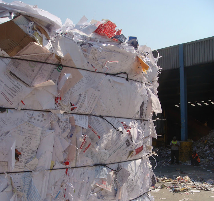 Bales of white paper await transport to a paper mill for their new life, possibly as tissue