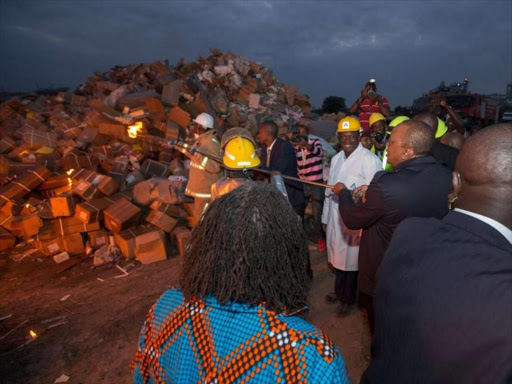 President Uhuru Kenyatta sets ablaze illicit goods worth Sh1.5 billion in Machakos on August 31, 2018. /PSCU