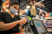 Checkers customer Chantel van Niekerk pays for her groceries using her eBucks loyalty card in Fairlands, Joburg.