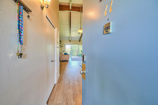 Entryway with keys and open living room in this luxury apartment / penthouse for sale in Salinas ($335,000)