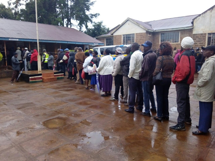 Voters wait to cast their votes in the General Election on August 8, 2017