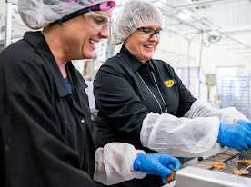 Two people making chocolate