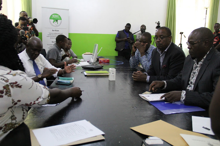 Homa Bay gubernatorial hopeful Evans Kidero and his running mate Elijah Kodo during clearance by IEBC returning officer Fredrick Apopa at the agency offices in Homa Bay town on June5, 2022.