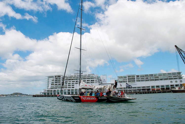 An America's Cup boat leaving Viaduct Harbour in Auckland. 