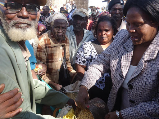 Embu Women representative Rose Mitaru distributing Famine relief food at Ngiiri Market in Mbeere North Sub-county on Jan 15 2015.Photo/Reuben Githinji