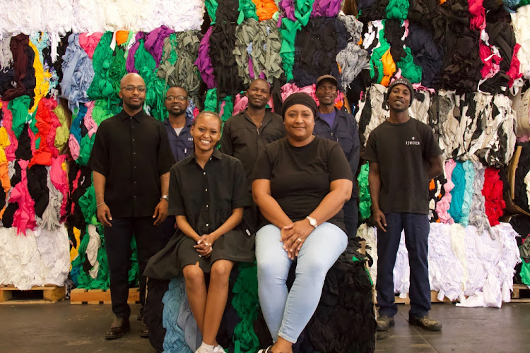 The Rewoven team from left to right: Tshepo Bhengu (co-founder & COO), Lulu Mayombo (recycling team member), Rams Magaya (recycling team member), Michael Rangayi (recycling team member), Steve Ndekha (operations supervisor). Front: Esethu Cenga (co-founder & CEO), Judith Elliot (office administrator).