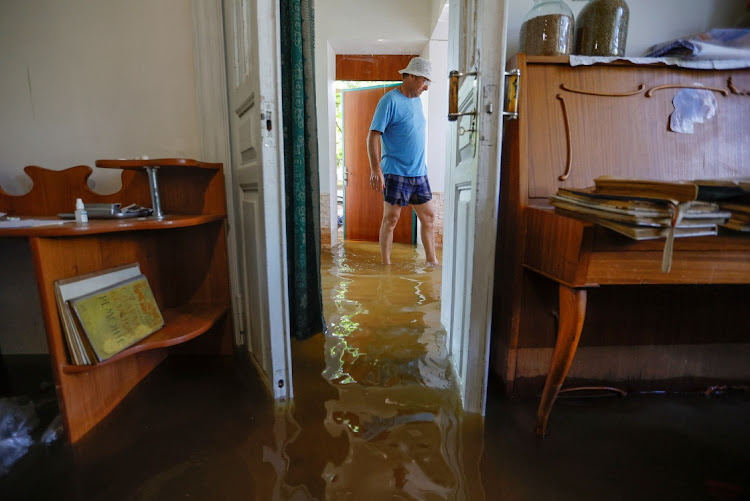 Local resident Valery, who did not give his family name, walks inside his house, which is submerged in water following the collapse of the Nova Kakhovka dam in the town of Nova Kakhovka in the Kherson region, Russian-controlled Ukraine, on June 7 2023. Picture: REUTERS/ALEXANDER ERMOCHENKO