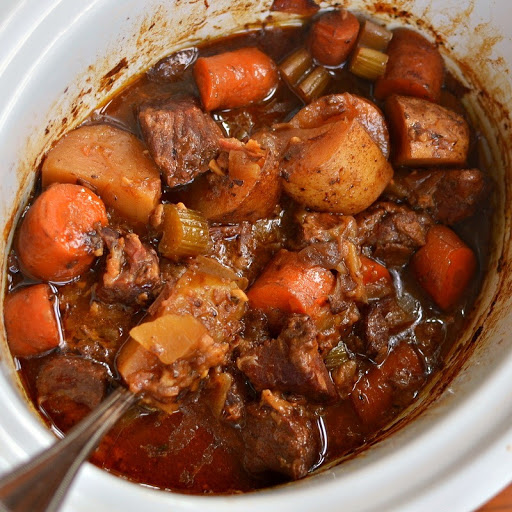 This Crock Pot Beef Stew recipe is plump full of onions, carrots, potatoes, celery, garlic and tender beef stew meat all nested together in a red wine reduction sauce with just a small kick of spice. 