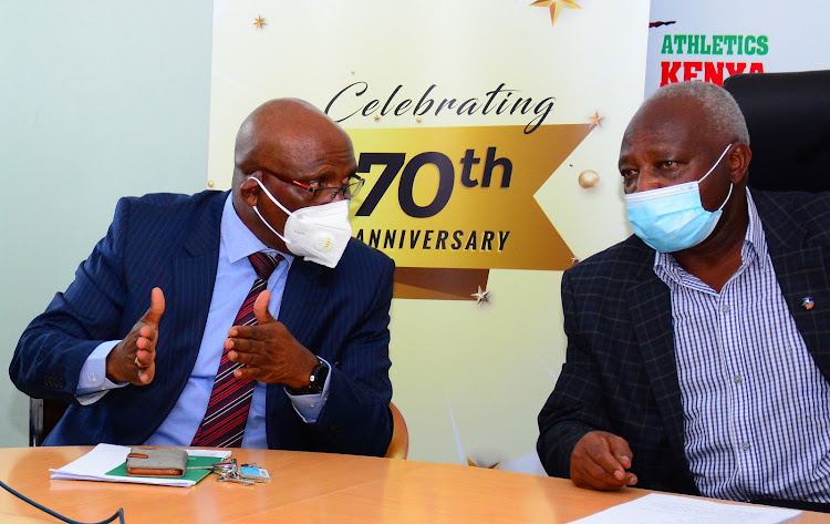 Athletics Kenya Treasurer David Miano (L) chats with president Jackson Tuwei during a press briefing on 70 years anniversary celebrations at Riadha House on December 14.