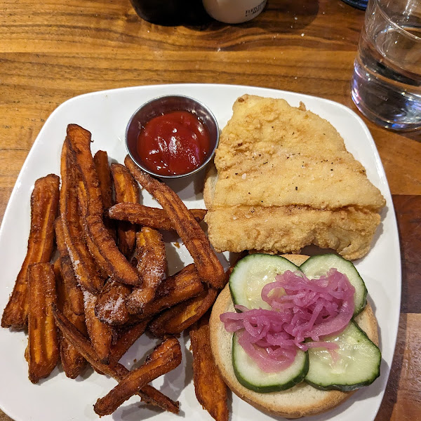 Sweet potato fries, fried fish sandwich with pickled radish, pickles, tartar sauce