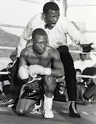 Johannes Miya kneels as referee Lolana Mtya administers the count after being knocked down Jija Sibali.
