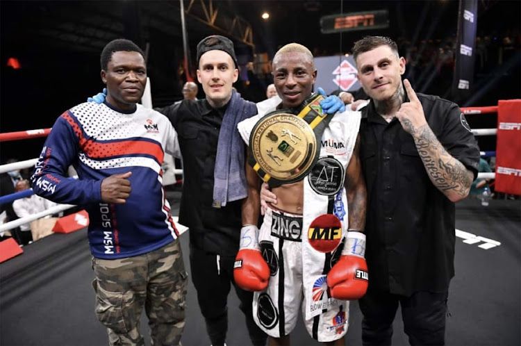 SA junior-light champ Sibusiso Zingange with manager Emmanuel Mutavhatsindi and trainers Julian Pot and Zaron Ramos.