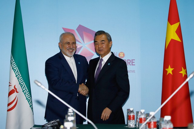 Iran's Foreign Minister Mohammad Javad Zarif and China's Foreign Minister Wang Yi shake hands at a bilateral meeting on the sidelines of the ASEAN Foreign Ministers' Meeting in Singapore, August 3, 2018.