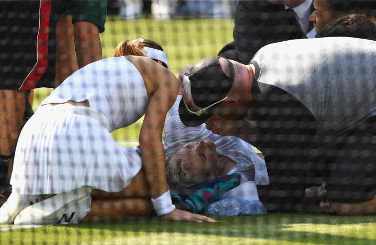 Bethanie Mattek-Sands receives treatment from the medical team and later retires from the Ladies Singles second round match against Sorana Cirstea of Romania.