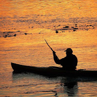 Remando in un fiume d'arancio di 