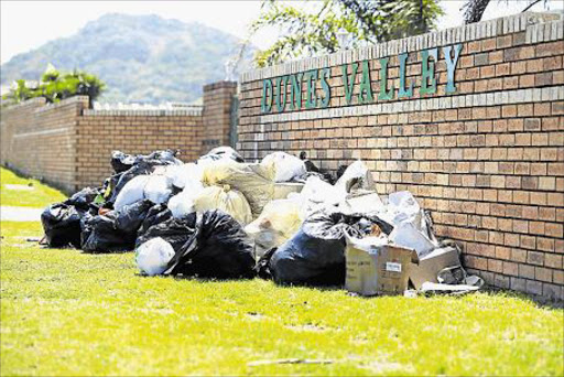 PILING UP: Rubbish piles up in Blue Bend yesterday as more black bags are added to a festering trash backlog not collected since last Monday due to a strike. The municipality says they are looking into it Picture: STEPHANIE LLOYD