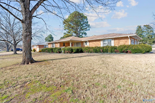 Brick house with tidy garden landscaping in this luxury property for sale in Huntsville ($340,000)