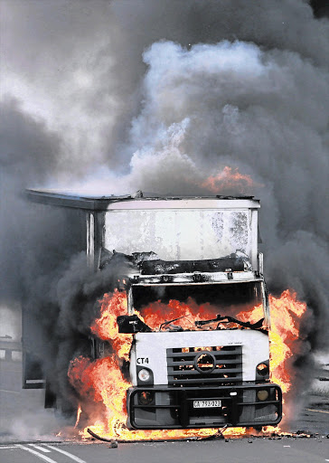 A burning truck that was petrol bombed in Cape Town during the truck drivers' strike.