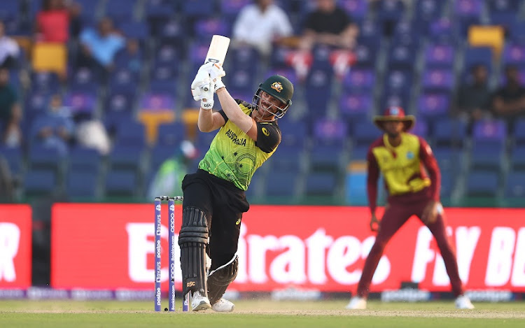 David Warner of Australia plays a shot during the ICC Men's T20 World Cup match between Australia and Windies at Sheikh Zayed stadium on November 06, 2021 in Abu Dhabi, United Arab Emirates.