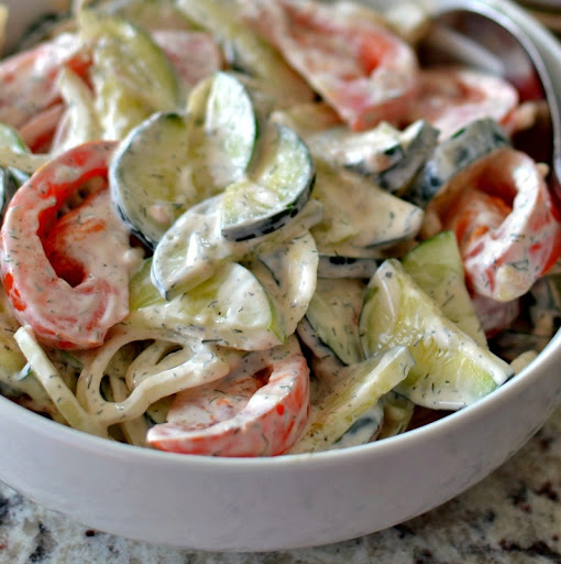 Creamy Cucumber Tomato Salad is fresh crisp cucumbers, sun ripened tomatoes and sweet onions in a luscious sour cream mayonnaise dill base.  