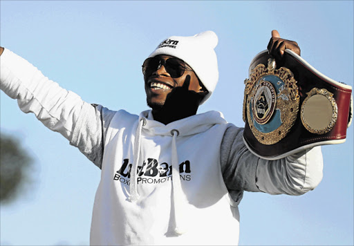 PLEASED AS PUNCH: Boxing superstar Zolani Tete with the fruits of his labours after his win a fortnight ago Picture: MARK ANDREWS