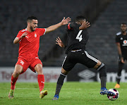 Happy Jele of Orlando Pirates challenges Elmehdi Elhouni of Al Ittihad during the CAF Confederation Cup 2021/22 match between Orlando Pirates and  Al Ittihad at Orlando Stadium in Soweto.