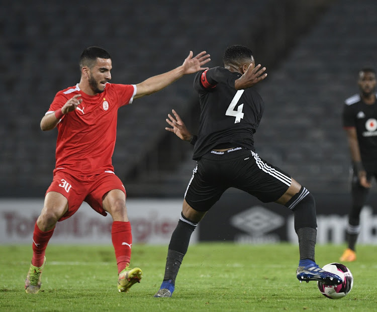 Happy Jele of Orlando Pirates challenges Elmehdi Elhouni of Al Ittihad during the CAF Confederation Cup 2021/22 match between Orlando Pirates and Al Ittihad at Orlando Stadium in Soweto.