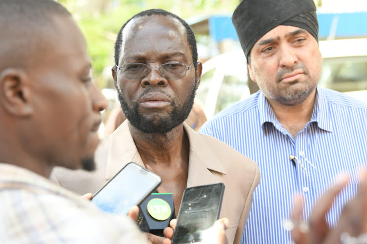 Kisumu Governor Anyang Nyong'o with Kibos Sugar and Allied Industries Limited company director Raghbir Singh