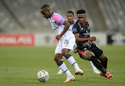 Thabo Nodada of Cape Town City is challenged by Lelethu Skelem of Maritzburg United in the DStv Premiership match at Cape Town Stadium on December 7 2021.