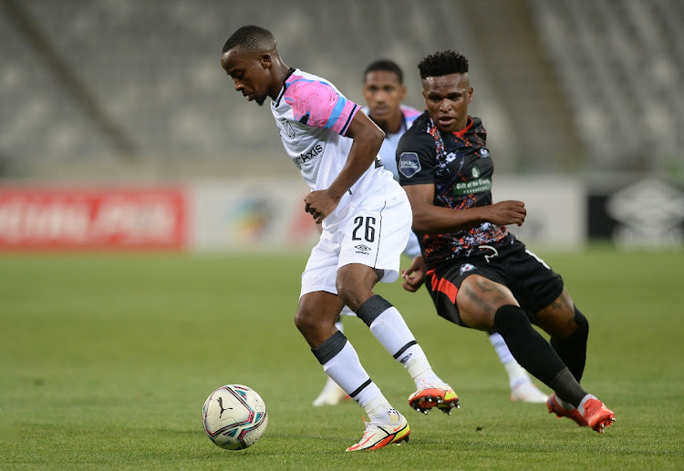 Thabo Nodada of Cape Town City is challenged by Lelethu Skelem of Maritzburg United in the DStv Premiership match at Cape Town Stadium on December 7 2021.