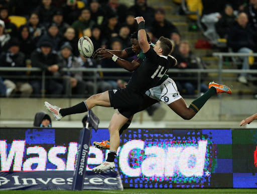 Cory Jane of the All Blacks and Lwazi Mvovo of the Springboks compete for the ball during the Tri-Nations match between New Zealand and South Africa at Westpac Stadium on July 30, 2011 in Wellington, New Zealand