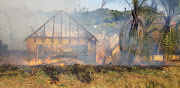 The gutted shell of a house burnt down by fires raging through Buffalo City on Monday.