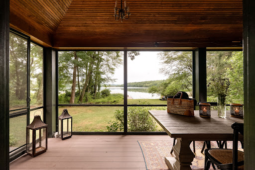 Porch with lake and tree view in this luxury property for sale in Salisbury ($2,550,000)