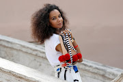 Italian-Haitian fashion designer Stella Jean shows the shoes she designed as she poses for a picture along the Spanish Steps ahead of the 