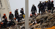 Rescue personnel continue the search and rescue operations for survivors at the site of a partially collapsed residential building in Surfside, near Miami Beach, Florida, US June 30, 2021. 