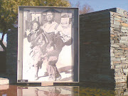 Outside the Hector Pieterson Museum in Soweto, South Africa, stands the famous picture by Sam Nzima of the child being carried by another pupil with his sister next to him.