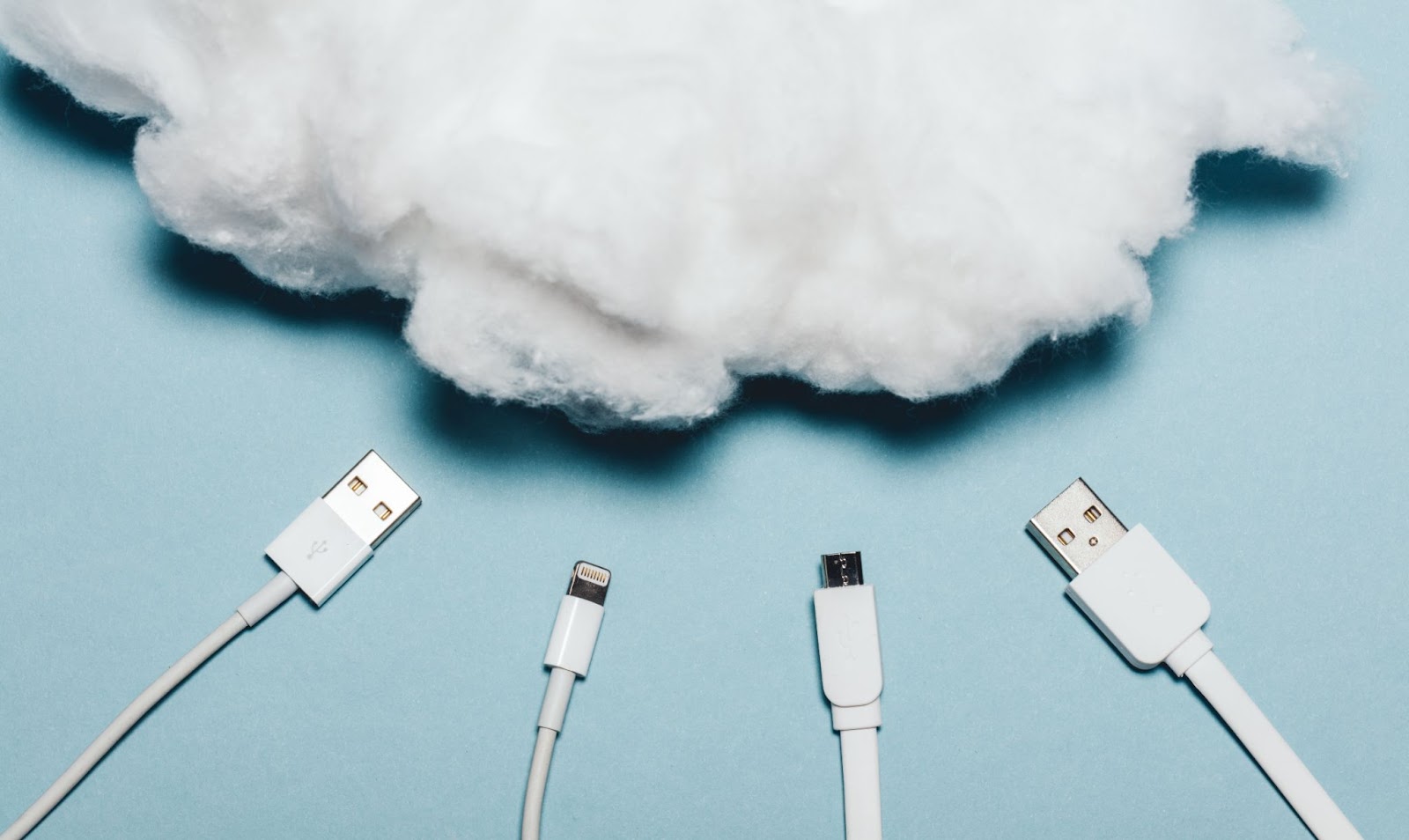 Four white wires laying under a white cotton cloud symbolizing data in the economic downturn.